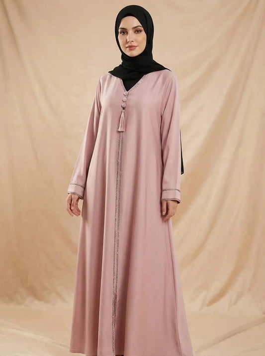 Woman wearing an elegant pink abaya with a black hijab for modest fashion in the UK | Alnoors Collections